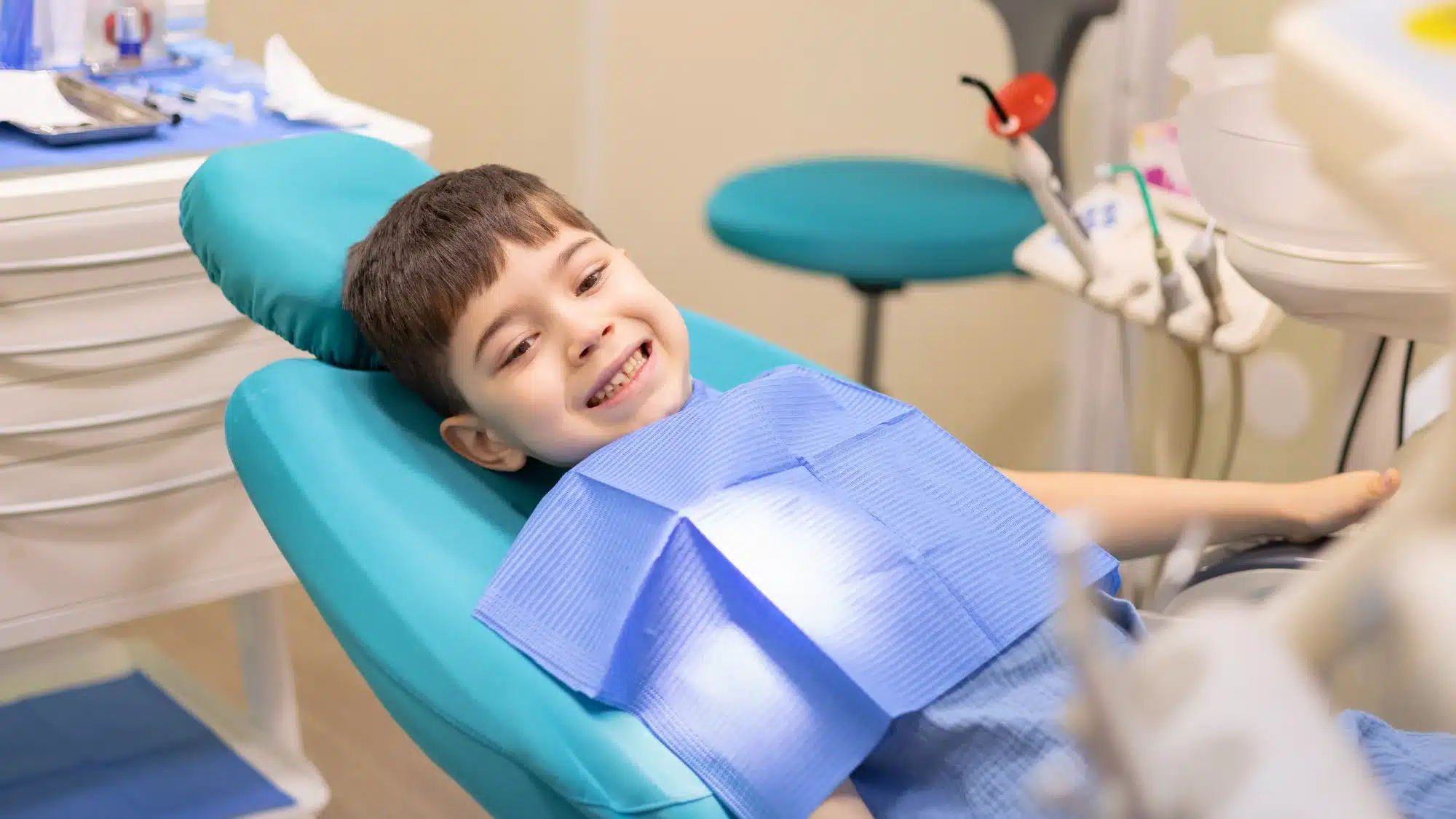 Smiling child in a dentist chair with a happy face