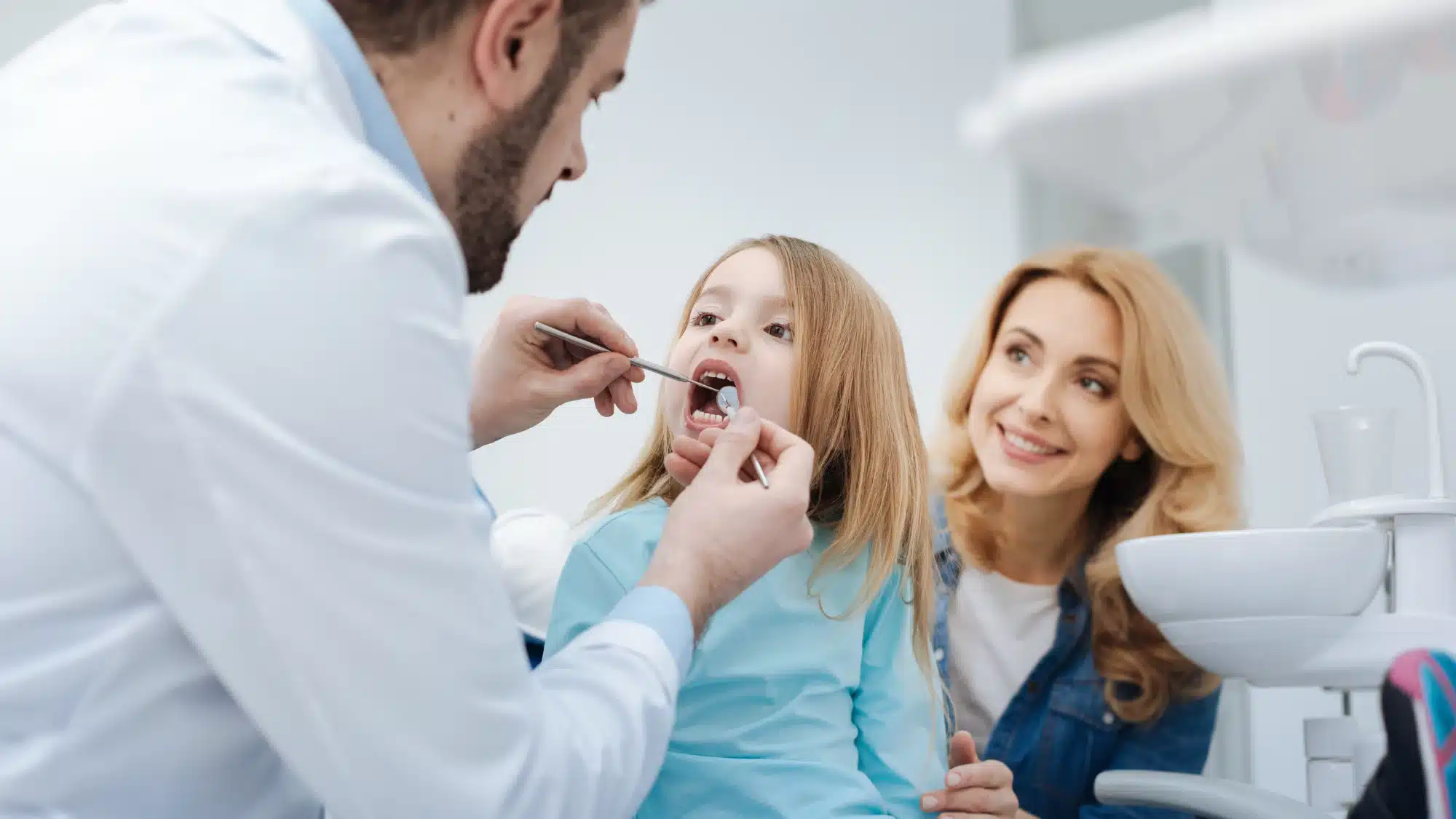 Smiling child in a dentist chair with a happy dentist