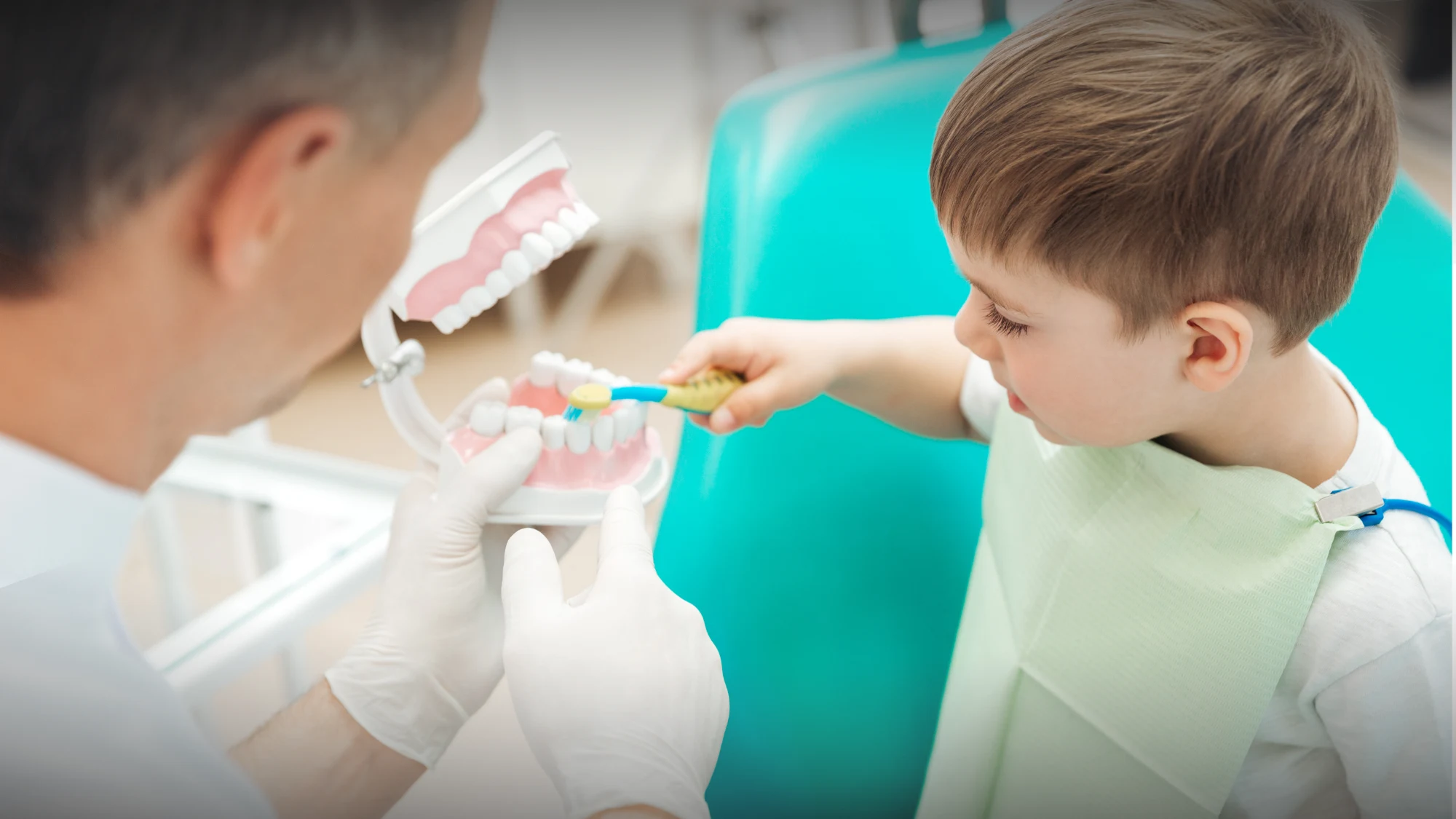 Pediatric dentists comforting a child at San Diego dental office